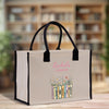 A beige tote bag with a printed design of books and flowers, and the text "Rachel's Version" printed on it.