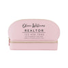 A pink makeup bag with the text "Olivia Williams REALTOR" printed on it.