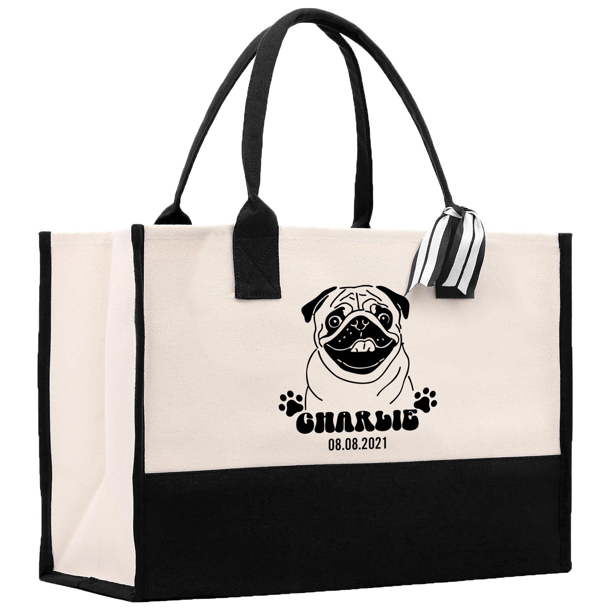 A large tote bag with a pug dog printed on it, featuring a date and a tag.