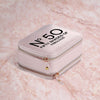 a white suitcase sitting on top of a marble floor