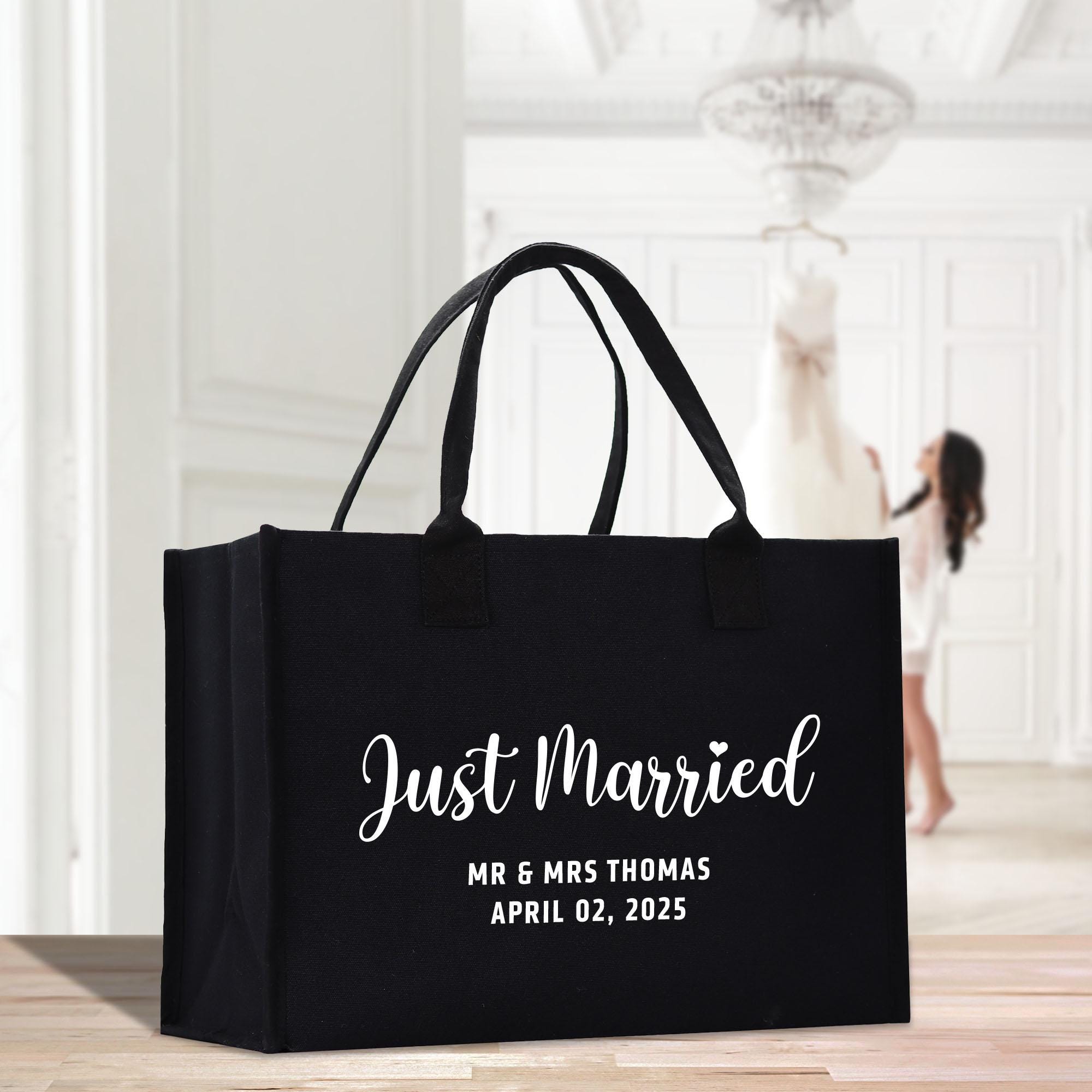 a black tote bag with the words just married printed on it