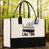 A black and white tote bag with a printed design on it, featuring a boat and the text 