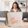 a woman sitting at a table with a bag that says girl pray about it