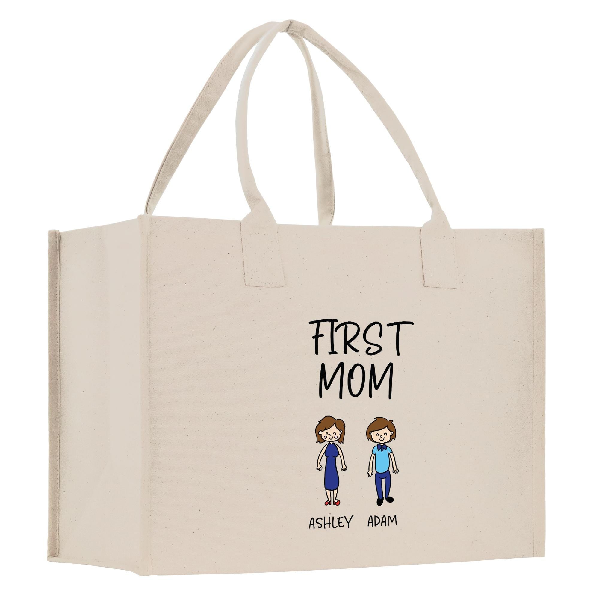 A beige canvas tote bag with a printed design featuring two cartoon-style figures and the text &quot;FIRST MOM&quot; above them.