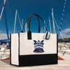 a white and black bag with a picture of a boat on it