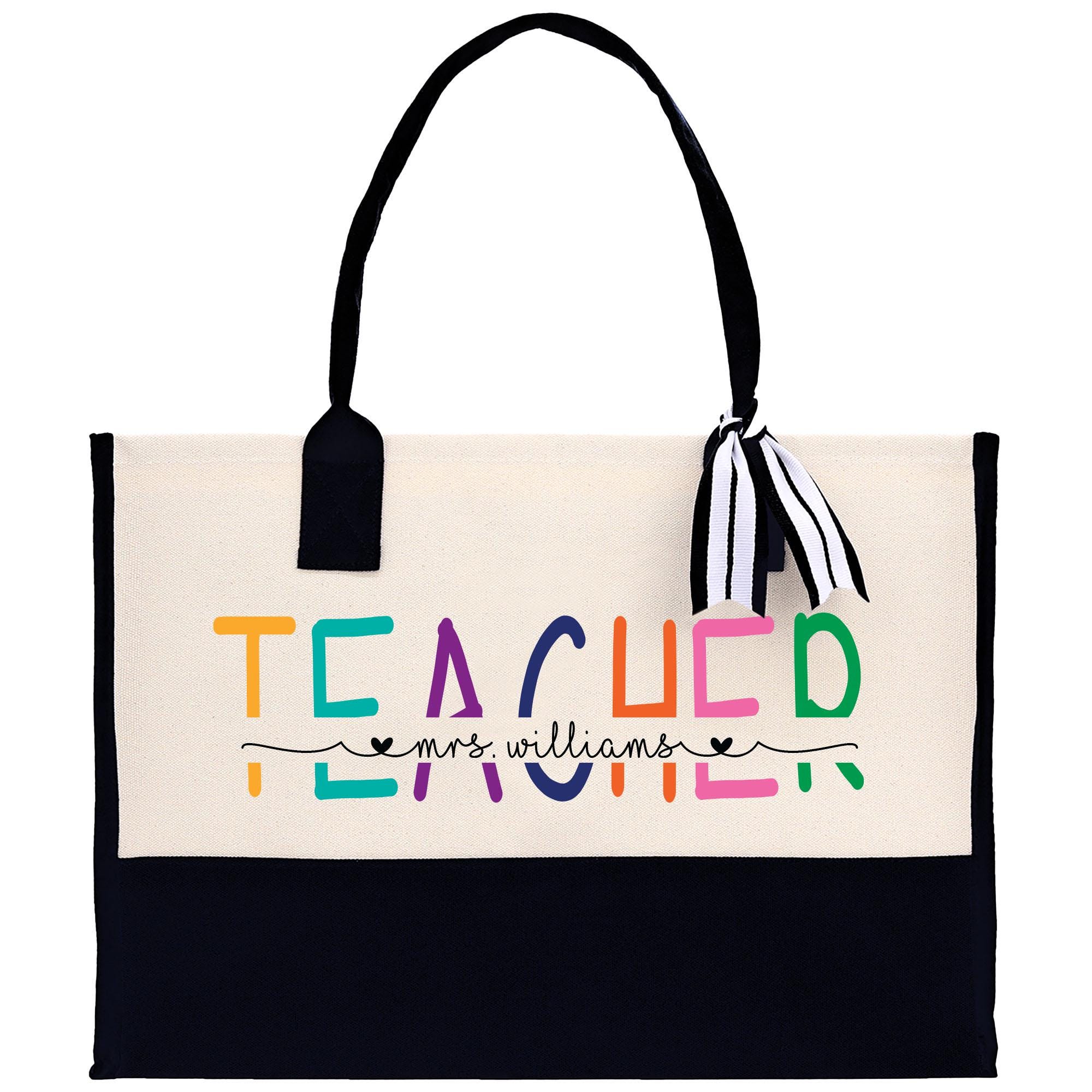 a white bag with a black handle and a teacher written on it