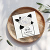 a card with a white rose sitting on top of a wooden plate