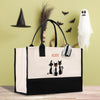 a black and white bag with two cats on it