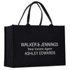 A black tote bag with white text printed on it.