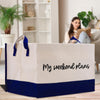 a woman sitting on a couch reading a book in front of a paper bag with