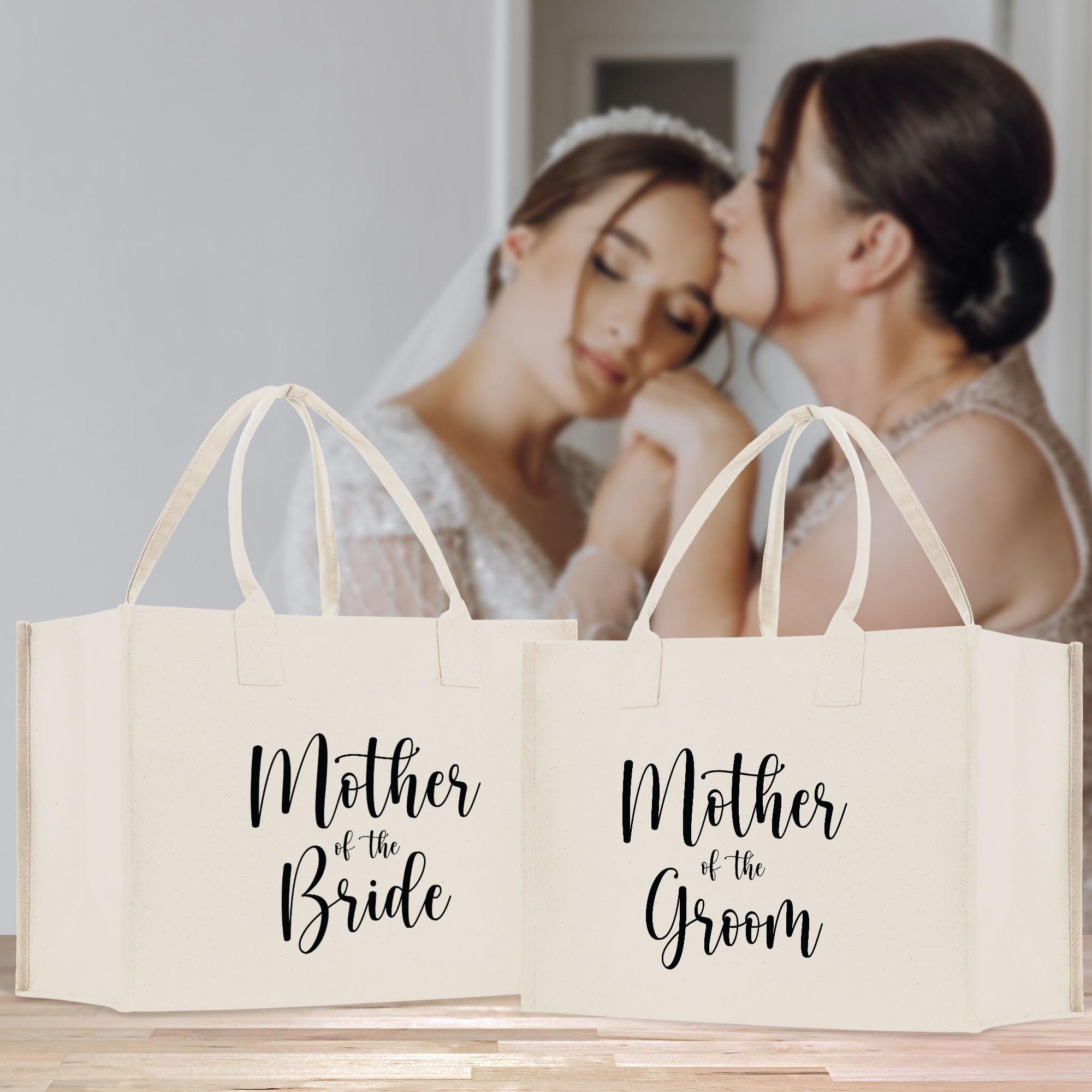 two brides kissing while holding shopping bags