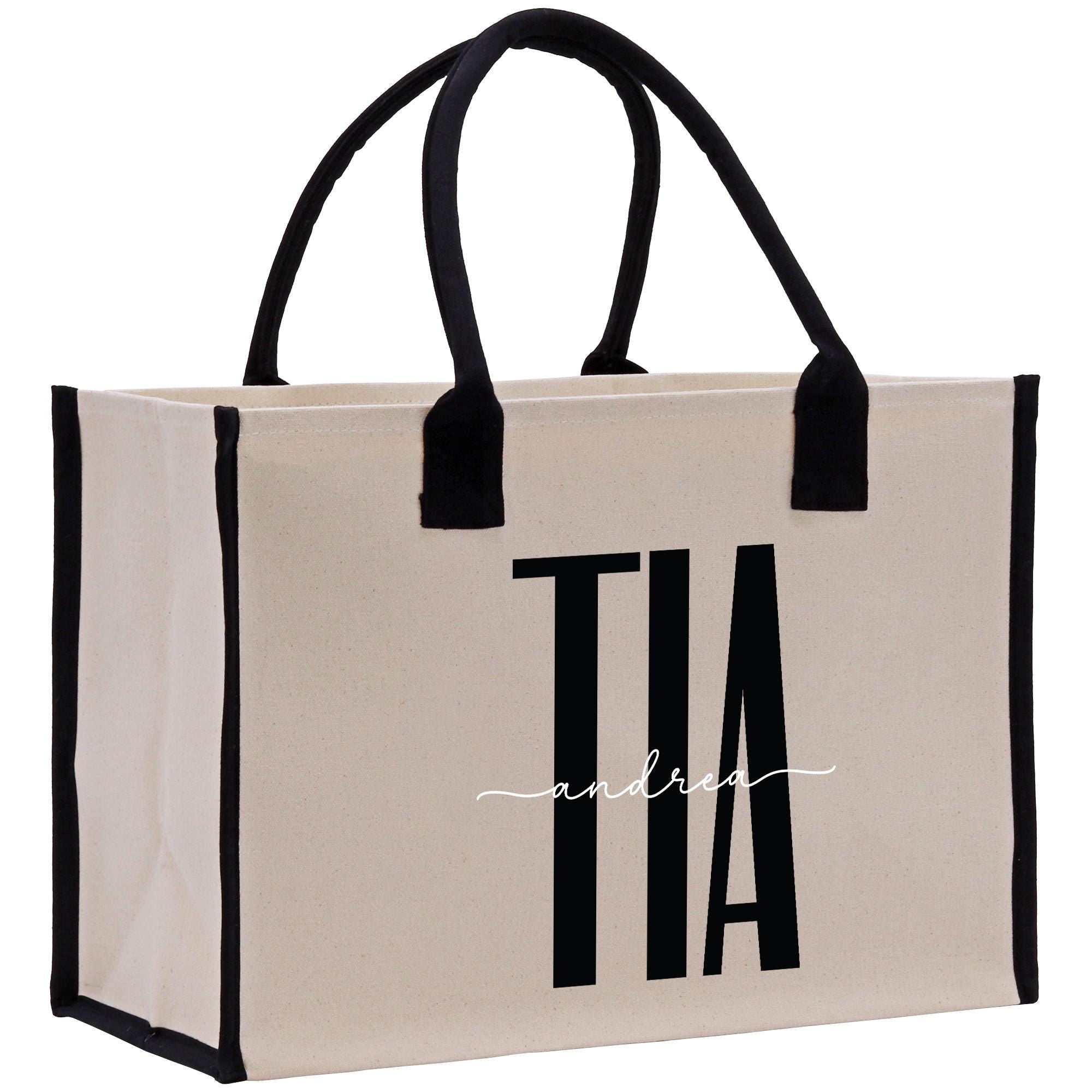 a white and black shopping bag with a logo on it
