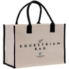 The image is a beige canvas tote bag with black handles and trim, featuring the text "The Equestrian Bag" and "Valerie Stables EST 2026" printed on it.