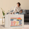 A white tote bag with a graphic design featuring a woman and mountains, along with the text 
