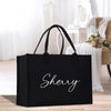 a black shopping bag with the word sheryl printed on it