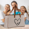 a woman and two girls are holding a bag
