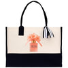 A tote bag with a printed image of a perfume bottle and flowers on it.