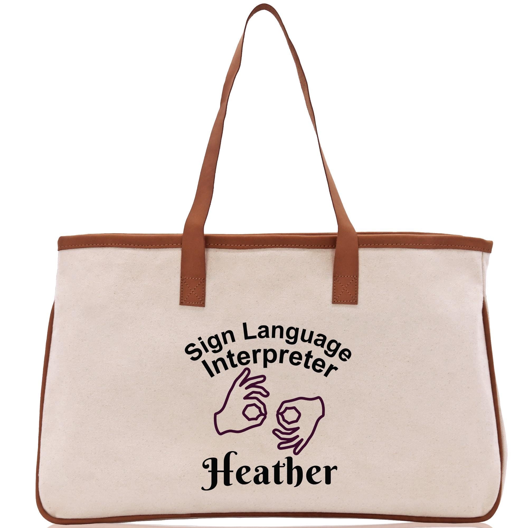 A beige canvas tote bag with a brown handle and a printed design on it.