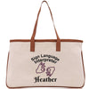A beige canvas tote bag with a brown handle and a printed design on it.