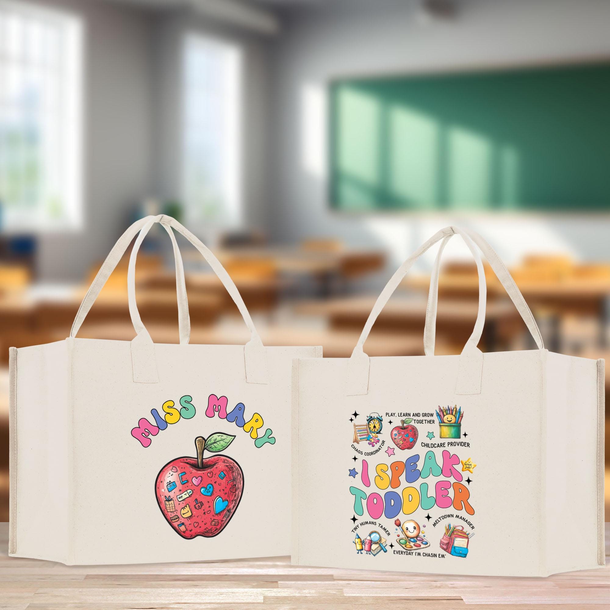 two bags with designs on them sitting on a table