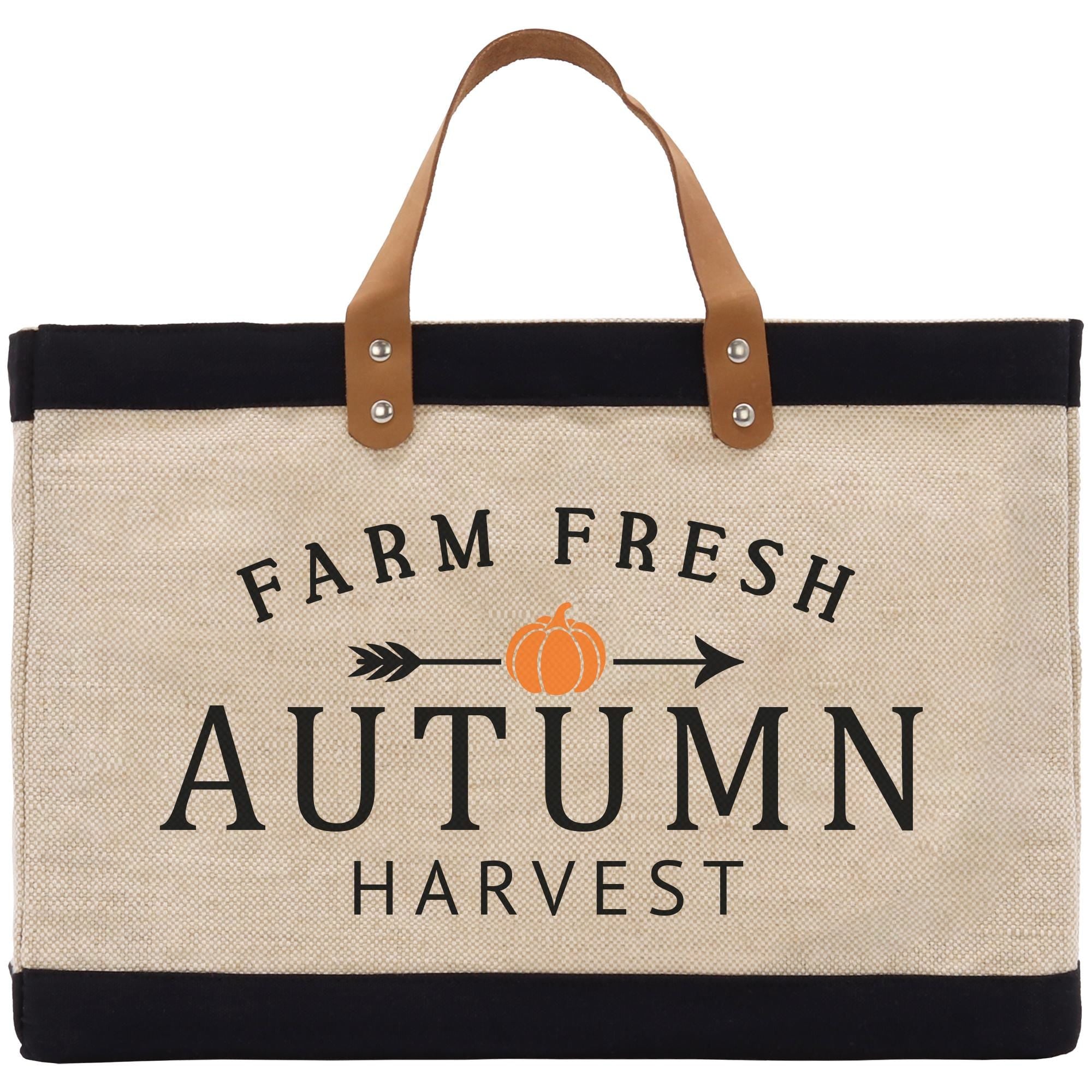 A beige tote bag with a black trim and a leather handle, featuring the text &quot;FARM FRESH AUTUMN HARVEST&quot; printed on it.