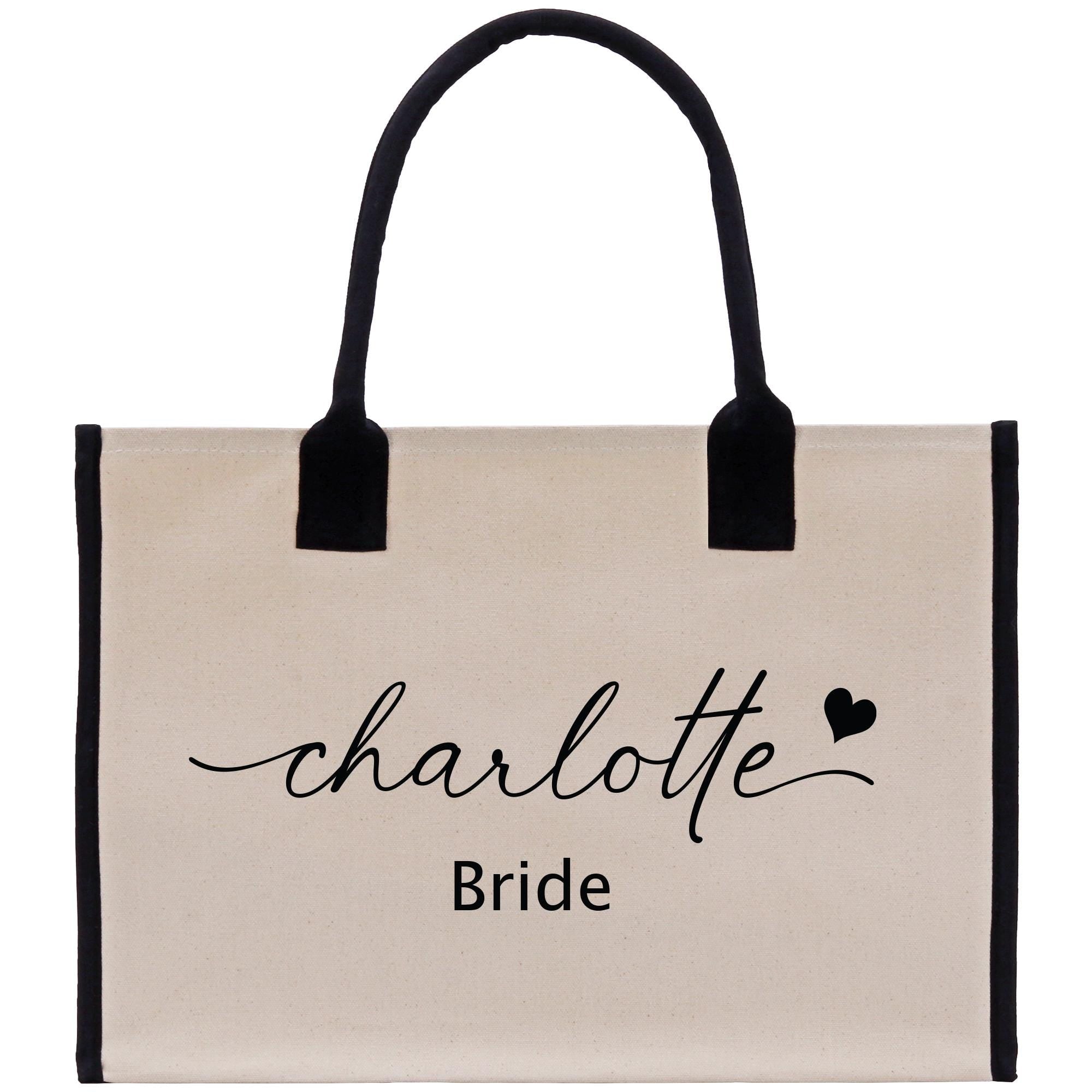 a white bag with a black handle that says charlotte bride