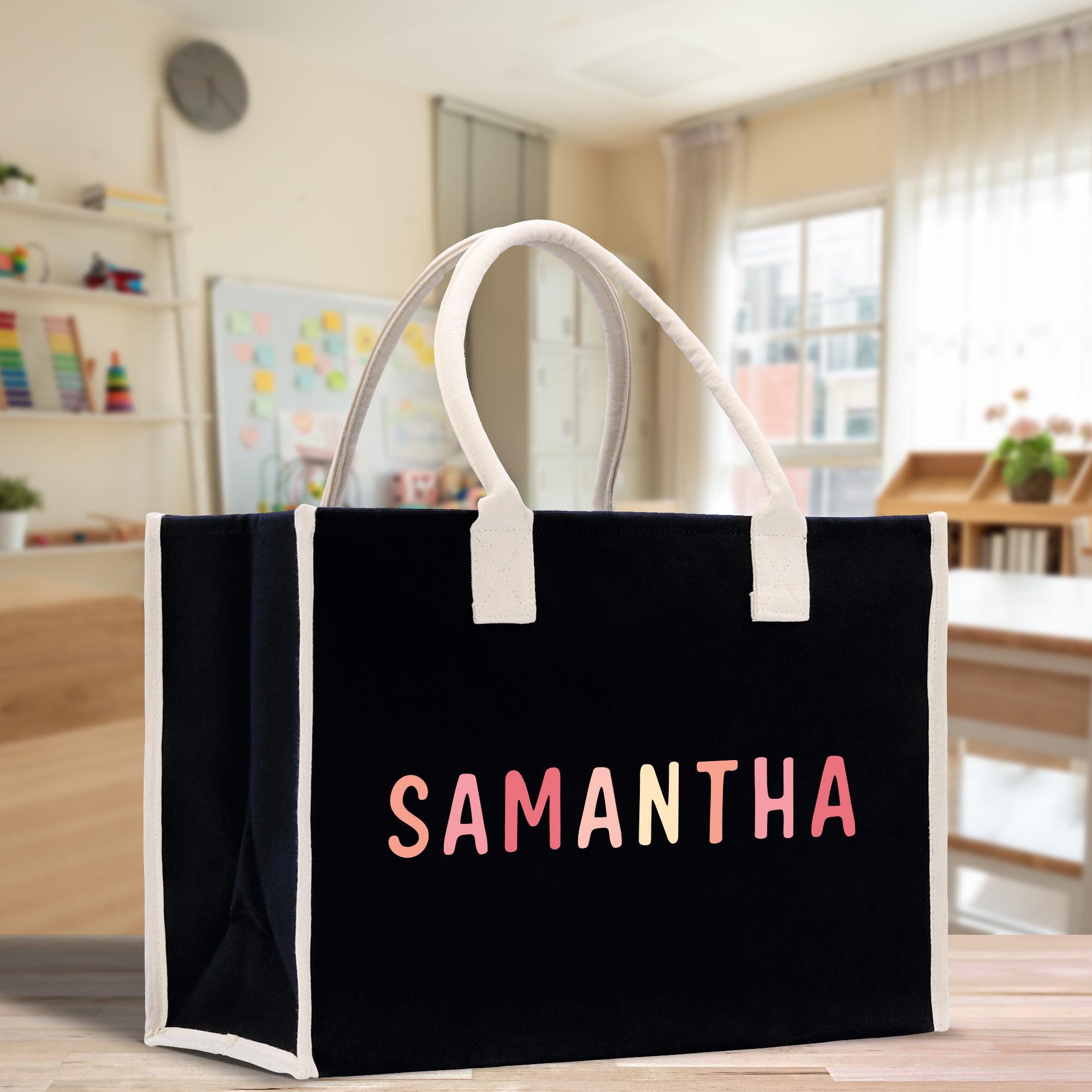 a black shopping bag with the word samantaha printed on it
