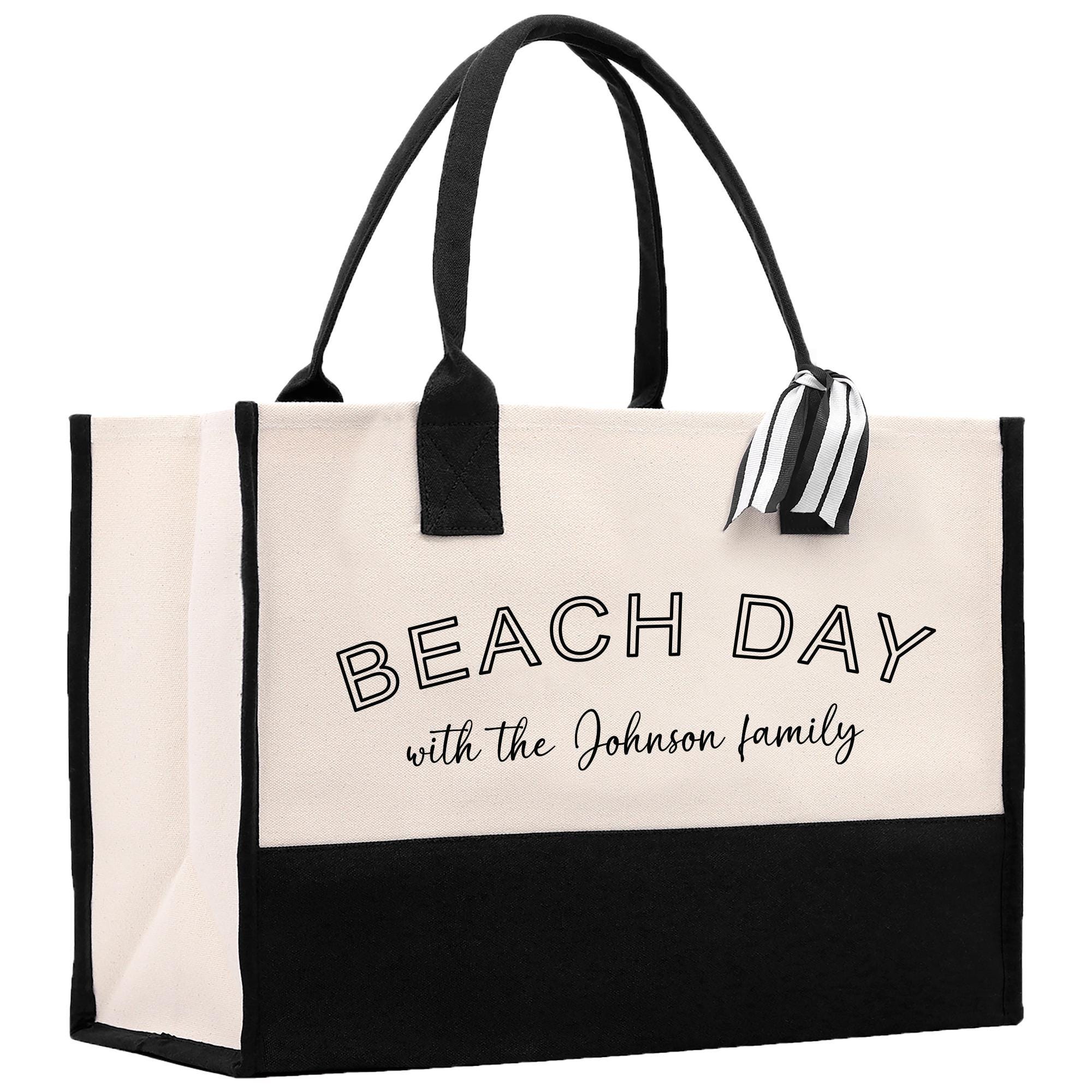 a black and white beach bag with the words beach day with the johnson family