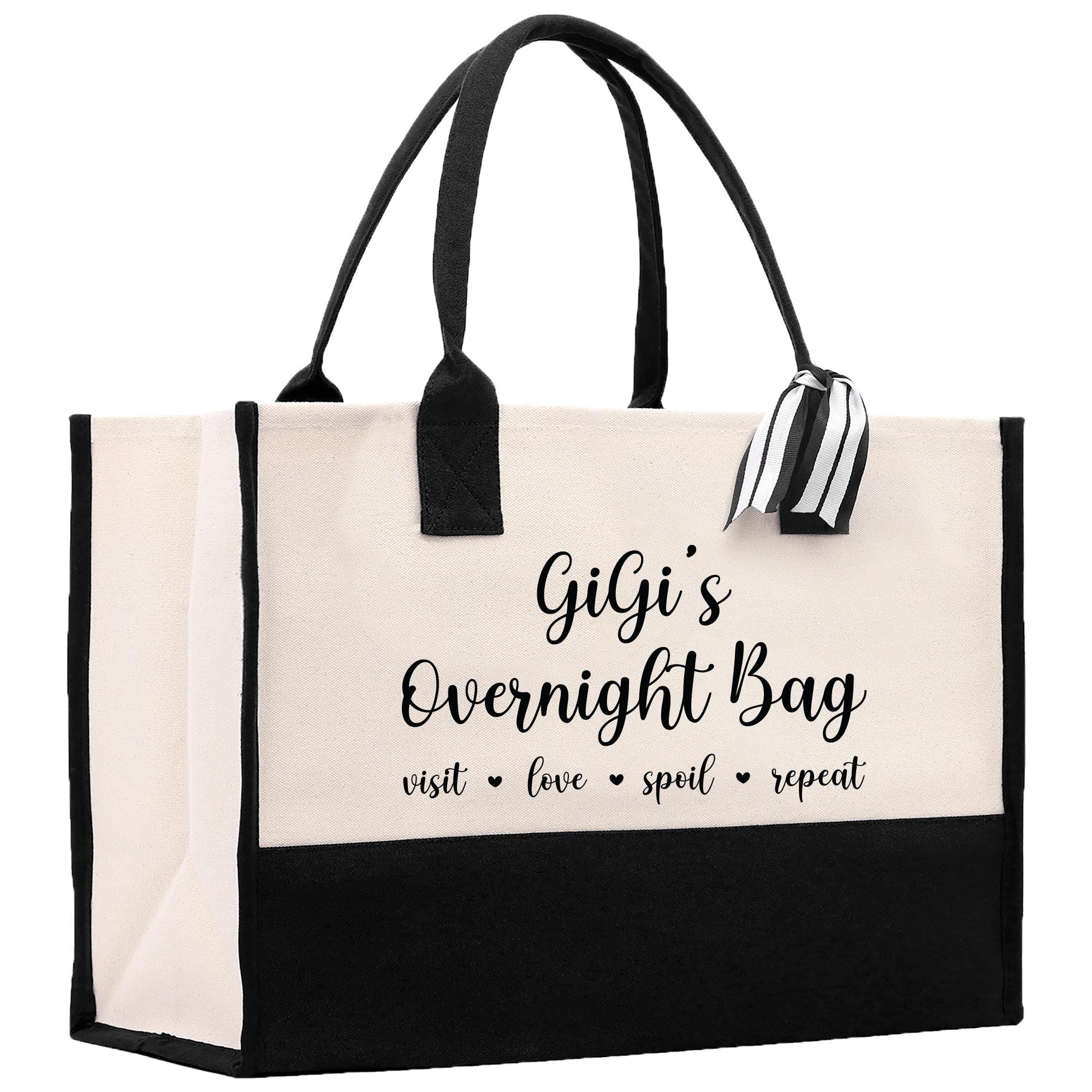 a black and white shopping bag with a bow on it