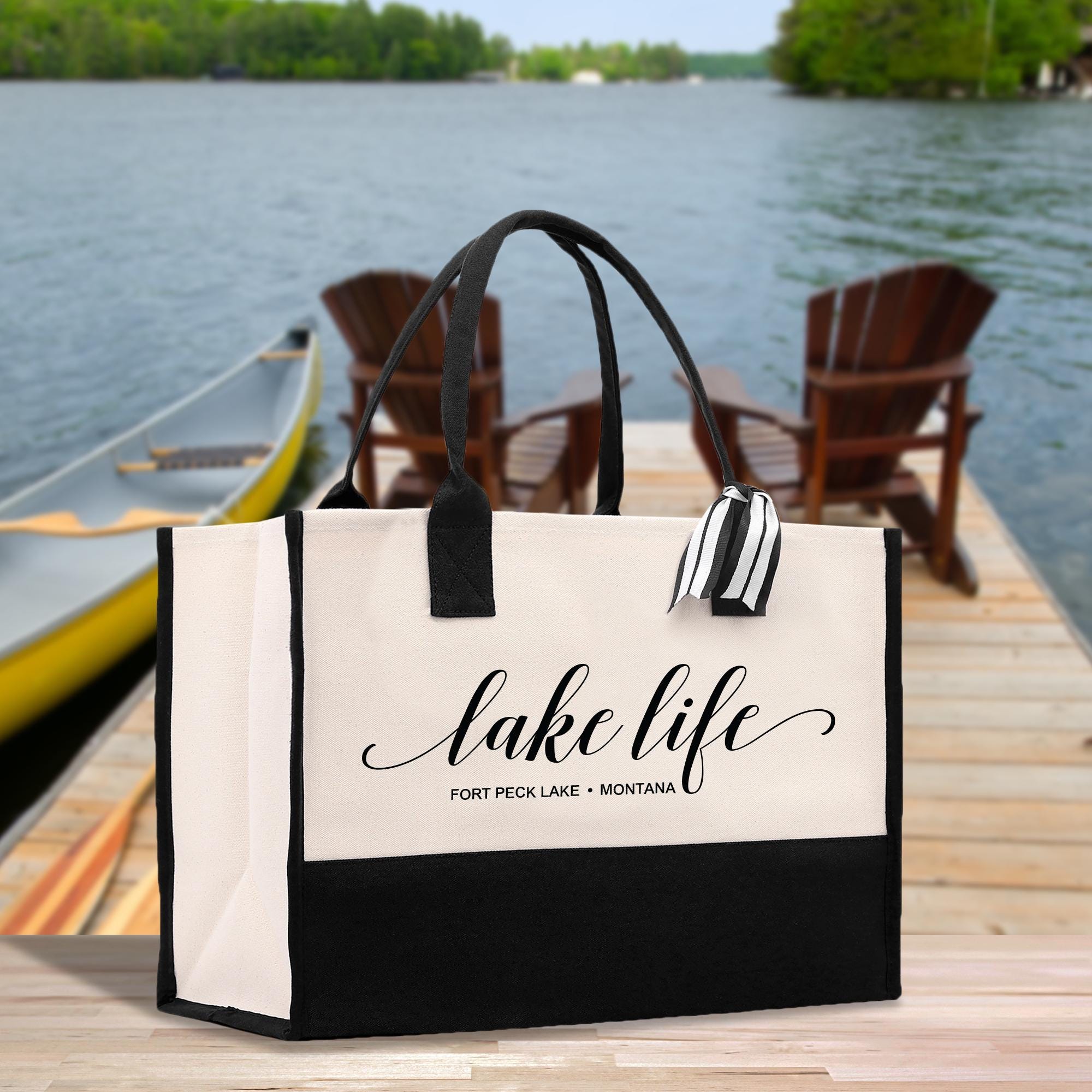 a black and white bag sitting on top of a wooden dock