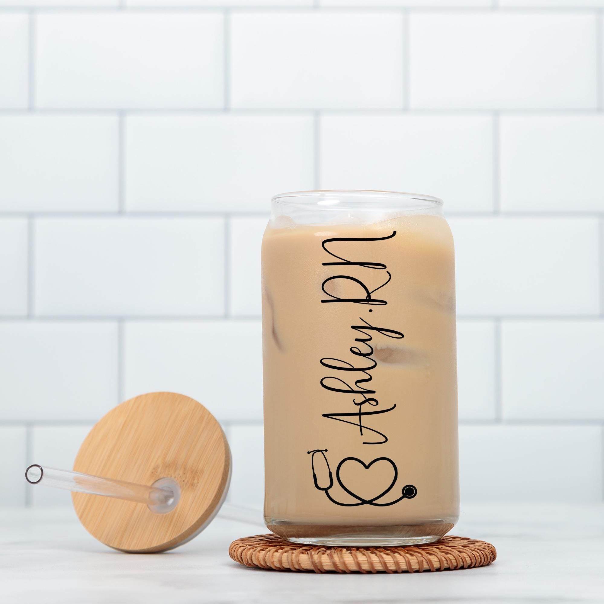 a glass jar with a wooden lid next to a white brick wall