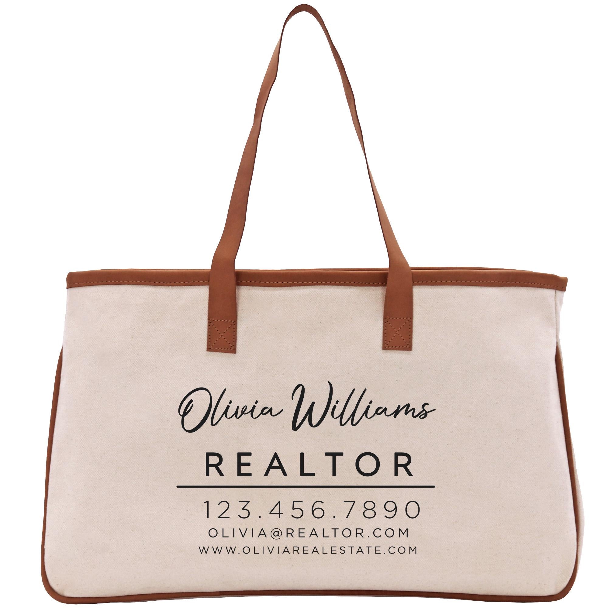 A beige tote bag with the text &quot;Olivia Williams REALTOR 123.456.7890 Olivia@REALTOR.com WWW.OLIVARESTATE.COM&quot; printed on it.