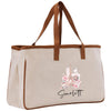 A beige canvas tote bag with a brown handle and a printed image of the Eiffel Tower on it.