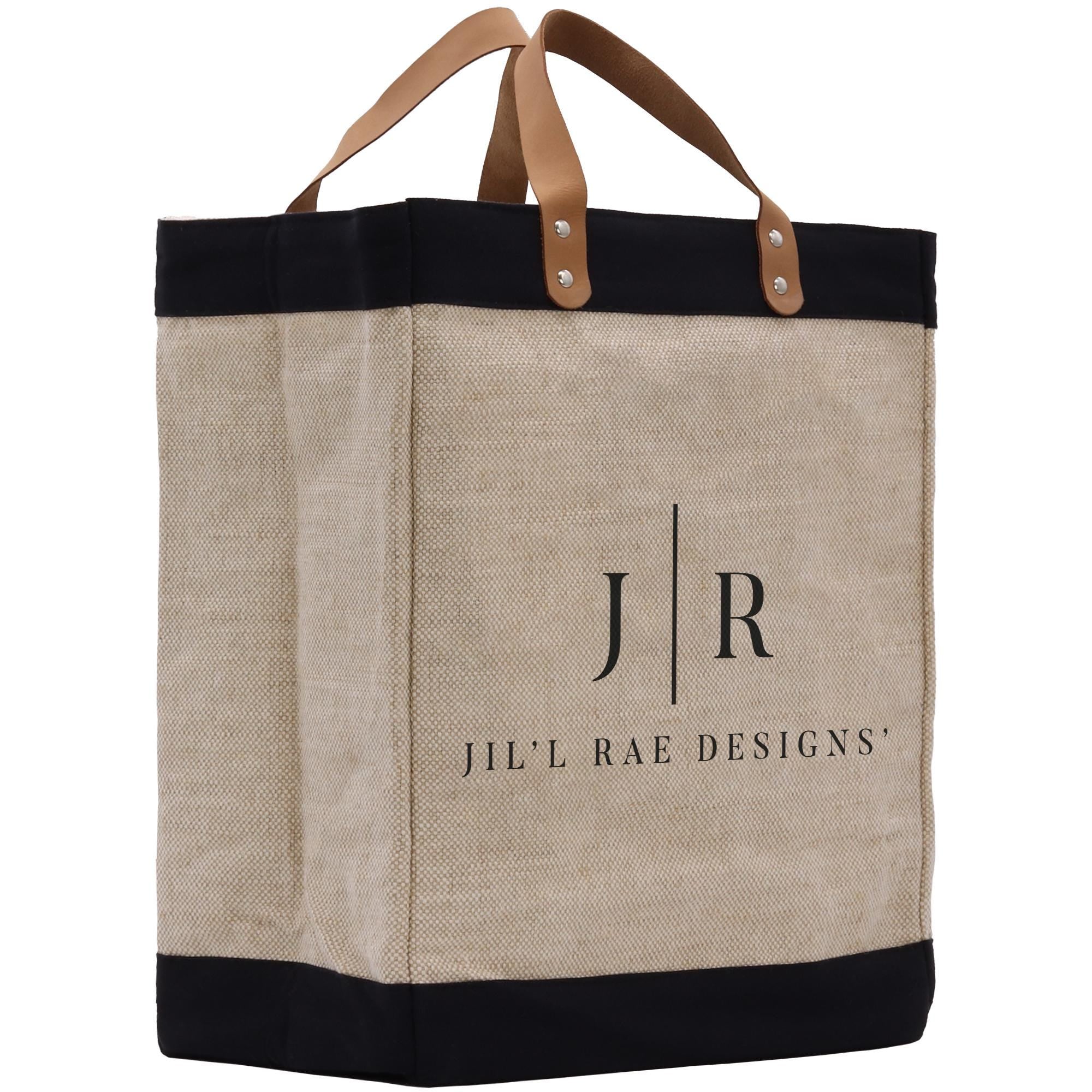 A beige tote bag with a black trim and leather handles, featuring the logo and text &quot;Jil&#39;l Rae Designs&quot; printed on it.