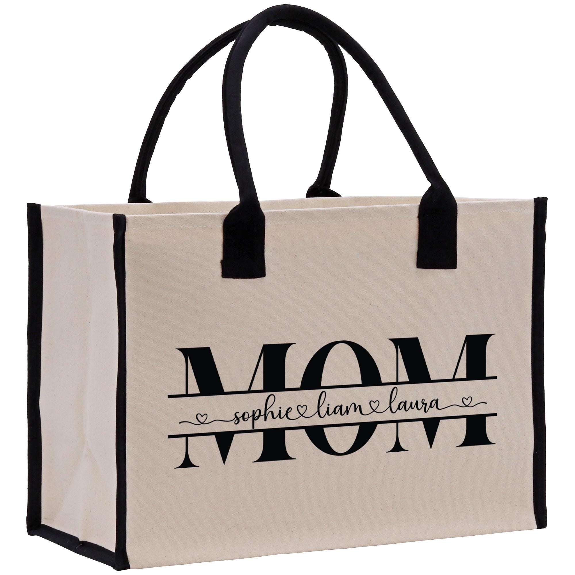 a white bag with black handles and the word mom printed on it