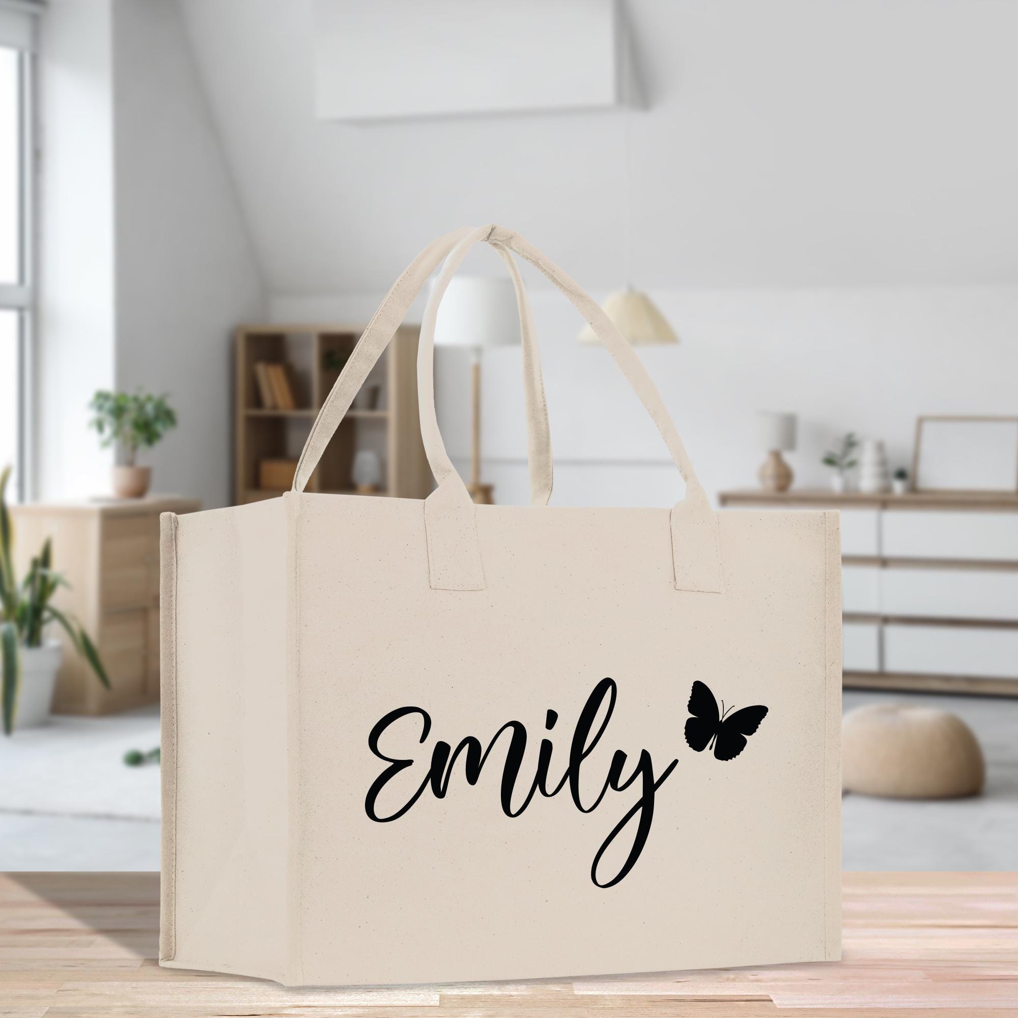 a white bag with a black name and a butterfly on it