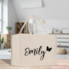 a white bag with a black name and a butterfly on it