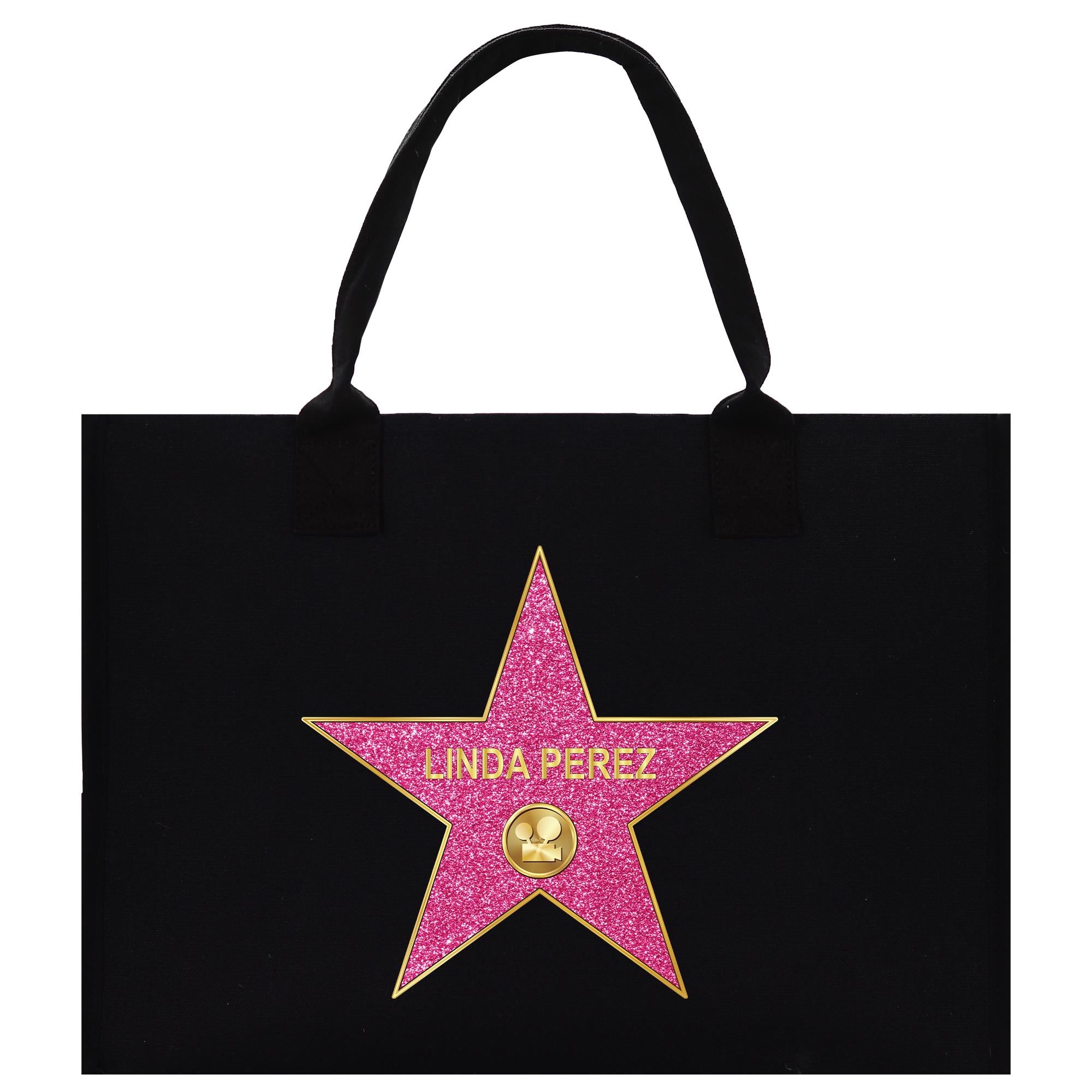 A black tote bag with a pink star-shaped logo featuring the name &#39;Linda Perez&#39; on it.
