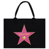 A black tote bag with a pink star-shaped logo featuring the name 'Linda Perez' on it.