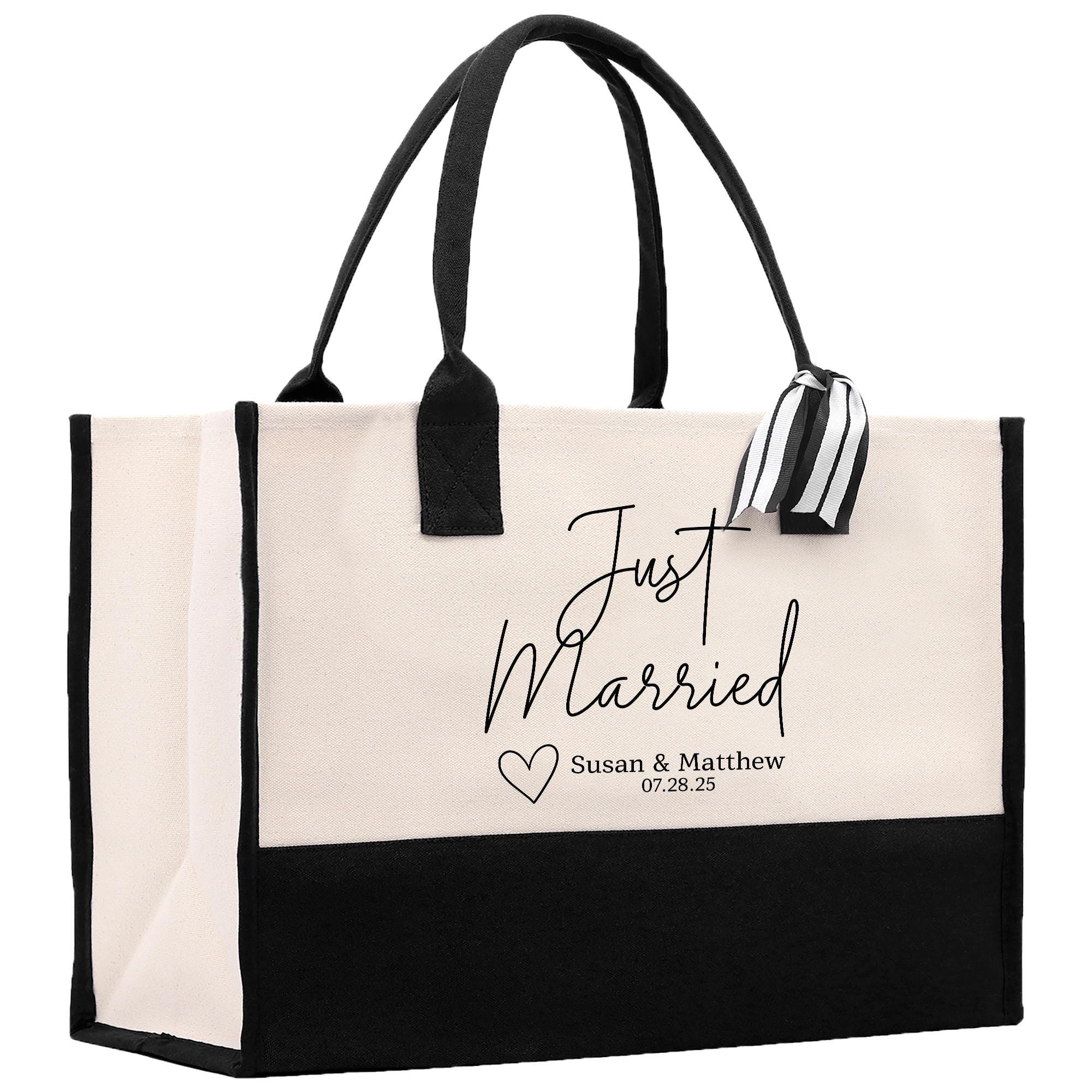 A large tote bag with a black and white design, featuring the text &quot;Just Married Susan & Matthew 07.28.25&quot; printed on it.