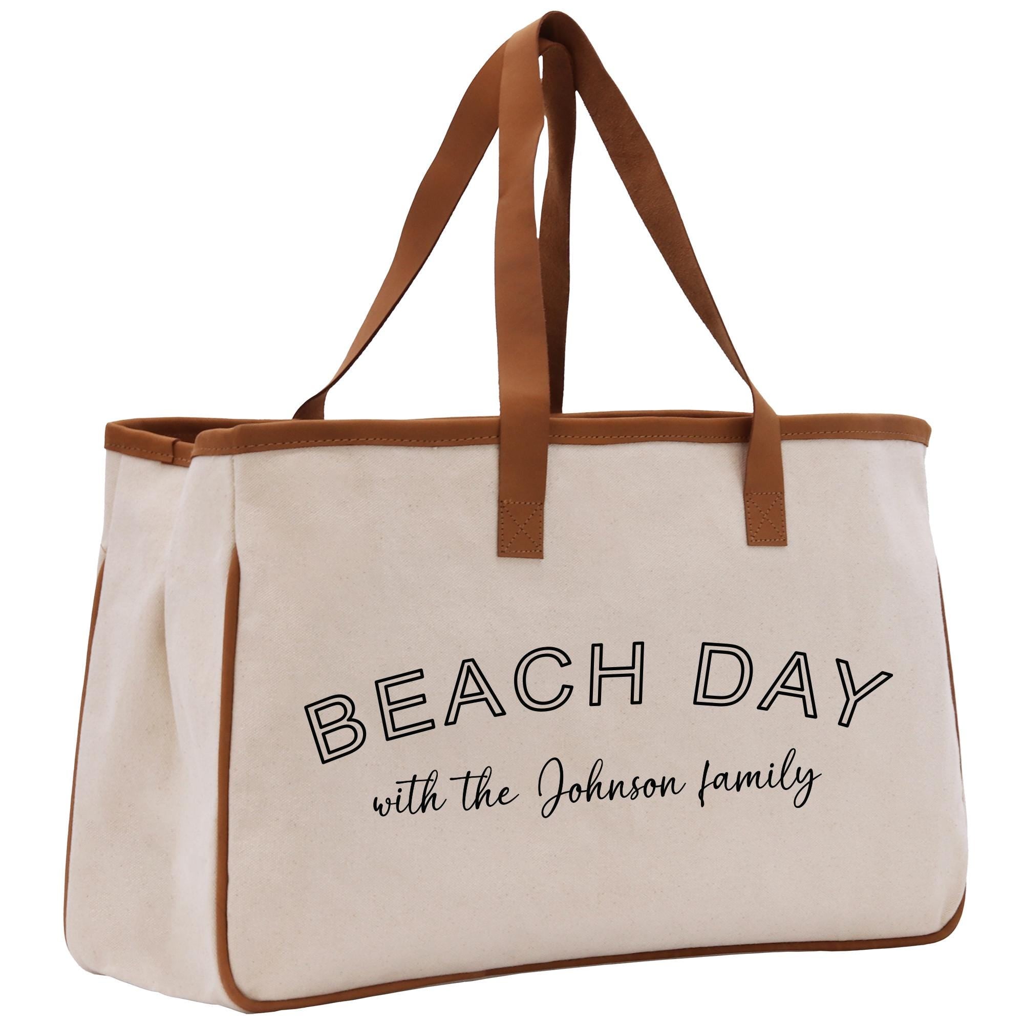 a white beach bag with the words beach day with the johnson family