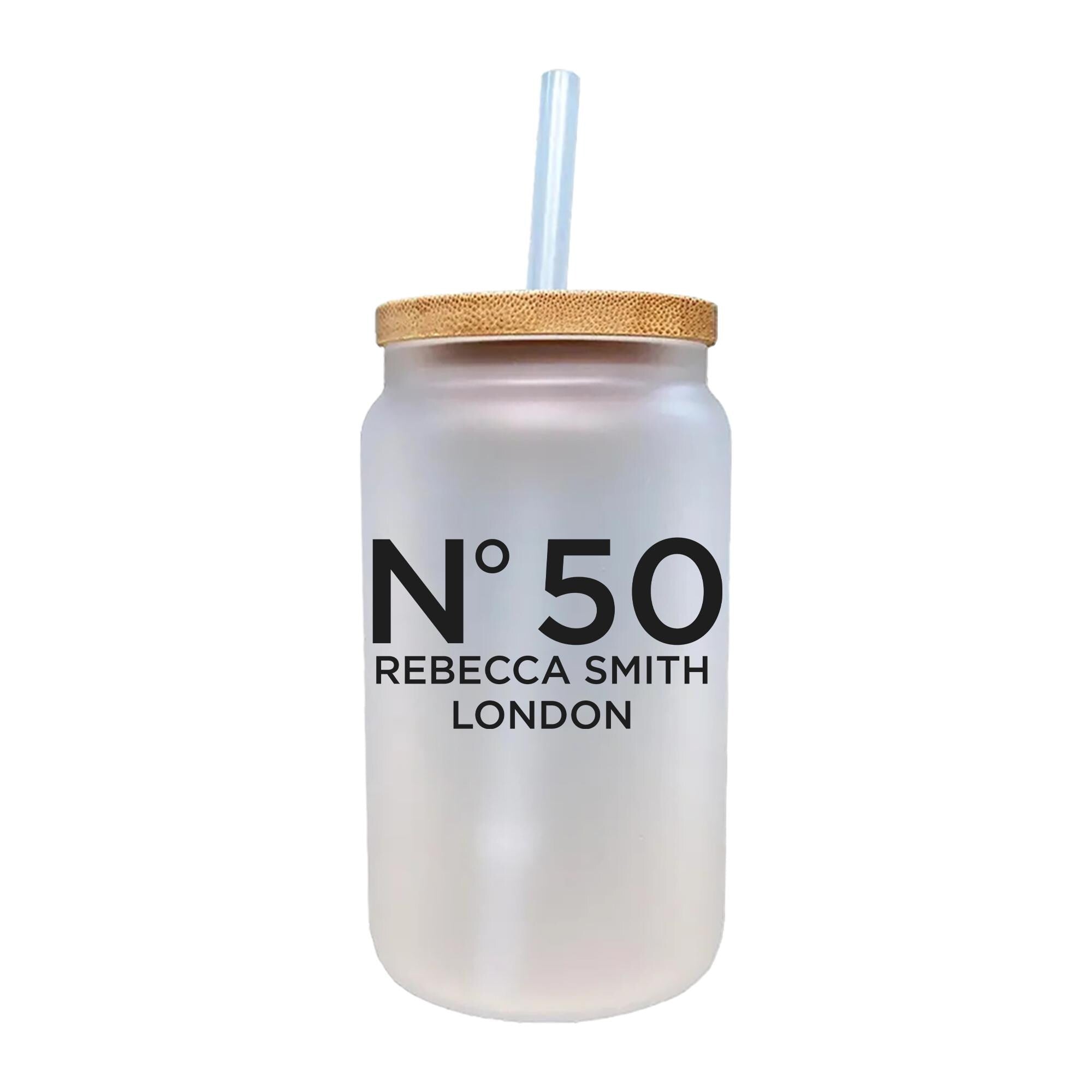 A frosted glass jar with a straw, featuring the text &quot;N°50 Rebecca Smith London&quot; printed on it.