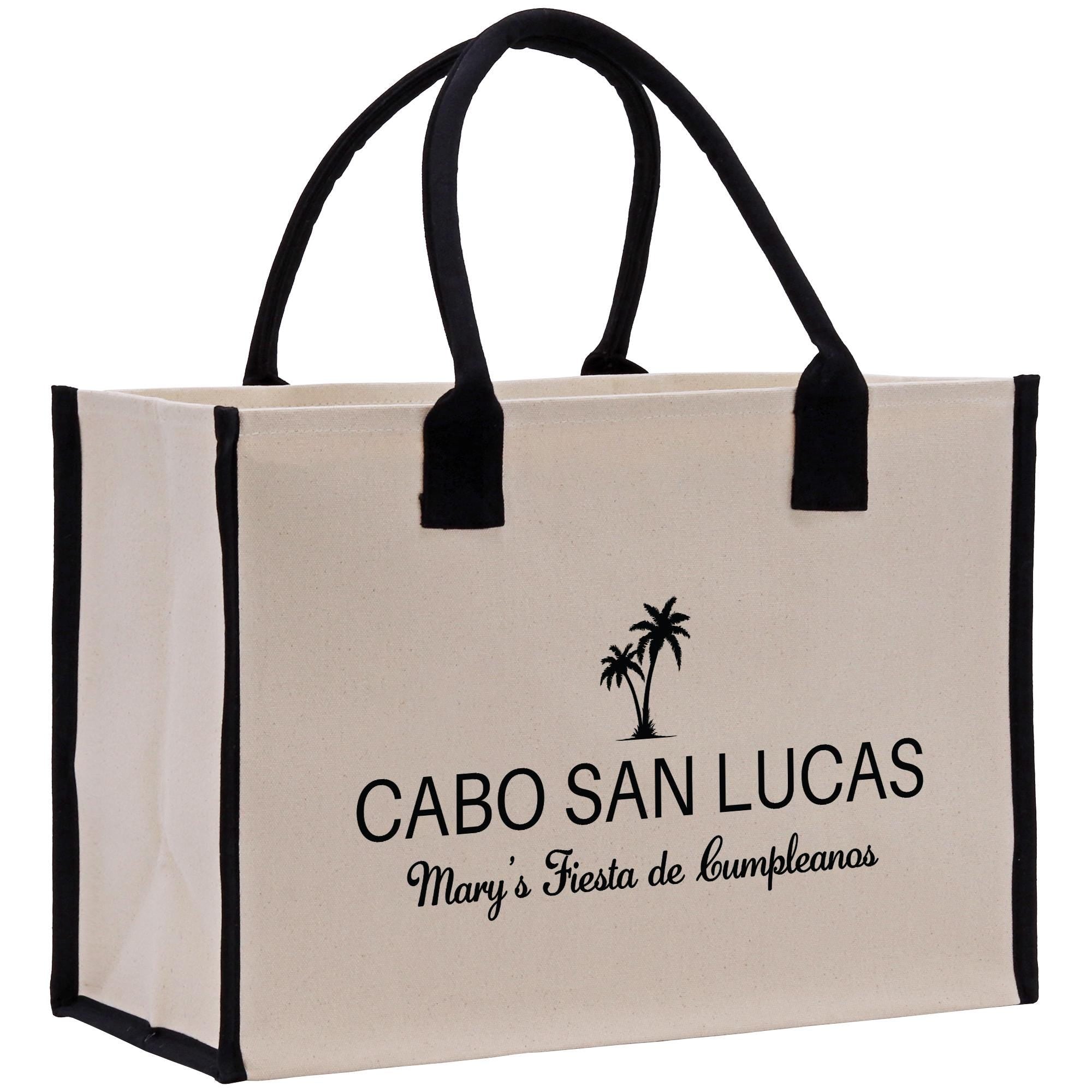 a white and black bag with a palm tree on it