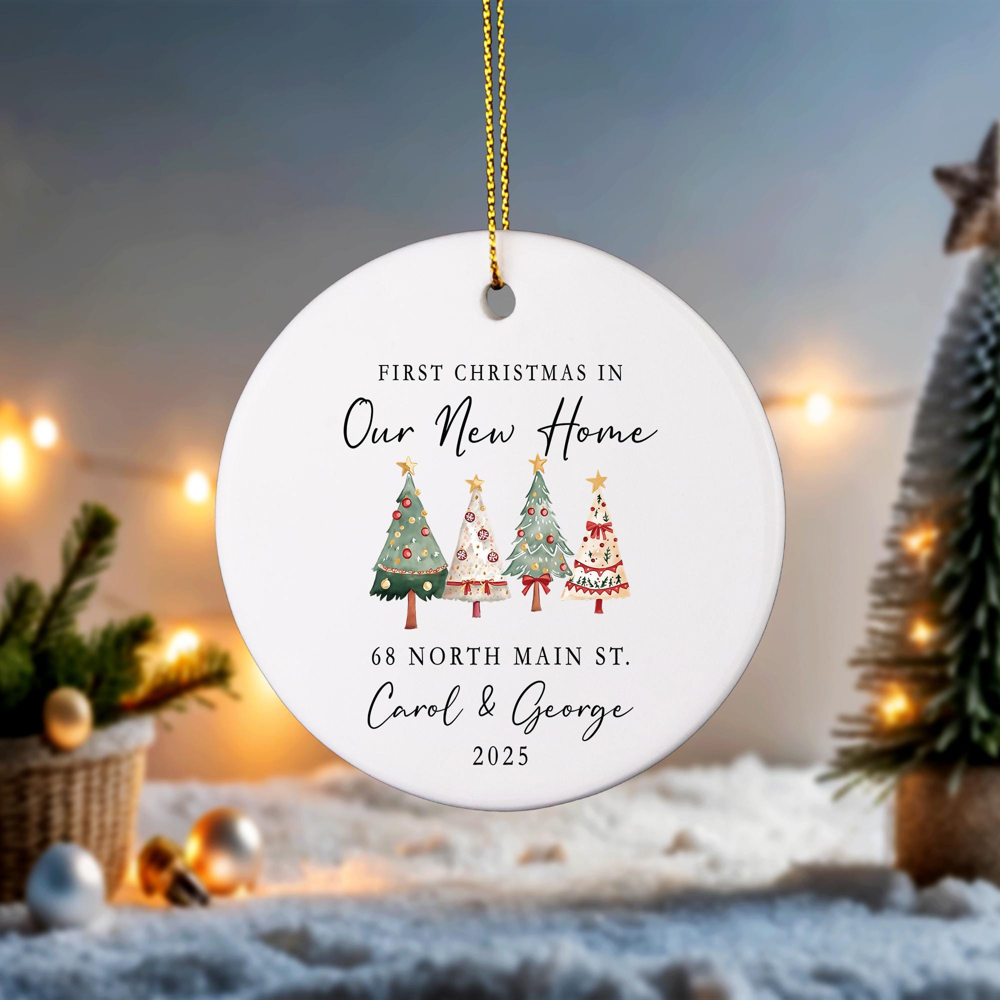 A white ornament with Christmas trees and text that reads &quot;First Christmas in Our New Home 68 North Main St Carol & George 2015&quot;.