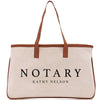 A beige canvas tote bag with the word "NOTARY" printed on it in black text.