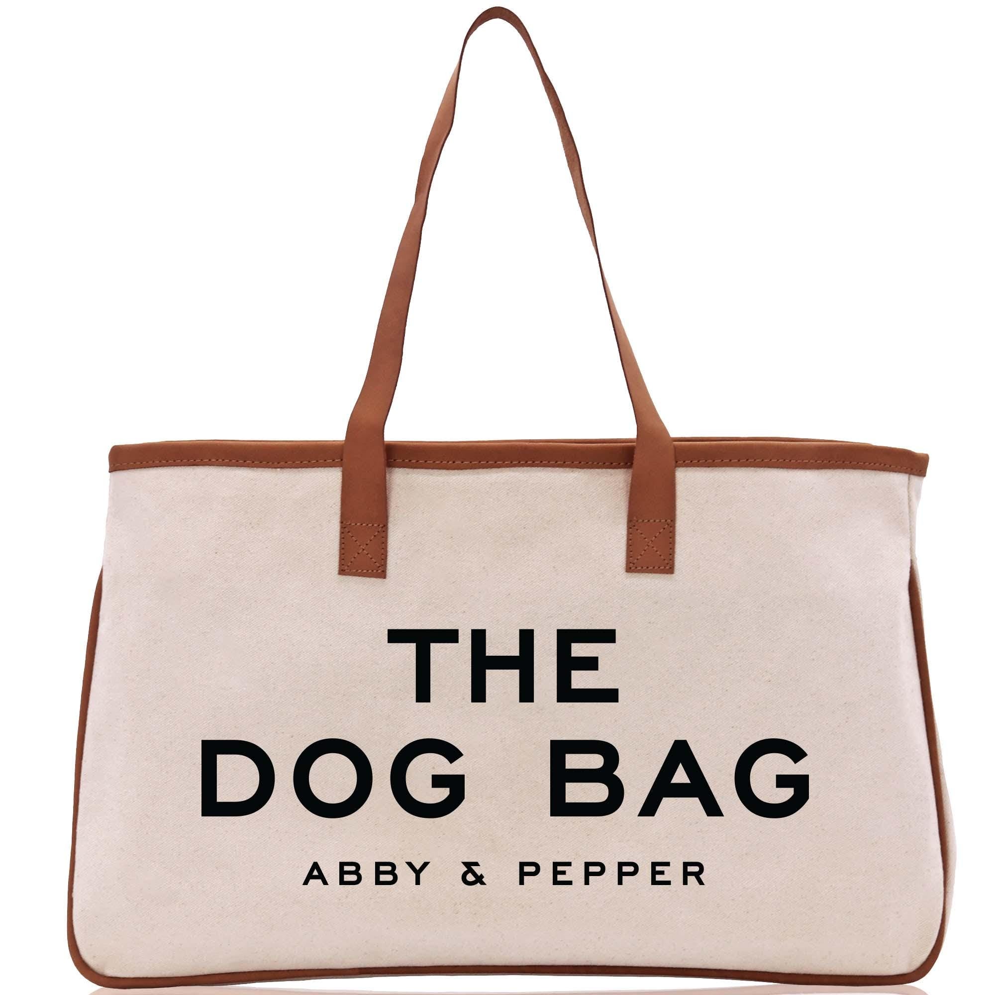 a white bag with a brown leather handle