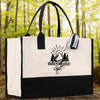 A black and white tote bag with the word 