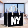 a black and white bag with the statue of liberty on it