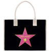 A black tote bag with a pink star-shaped logo featuring the name 'Linda Perez' on it.