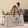 A large beige tote bag with the text 